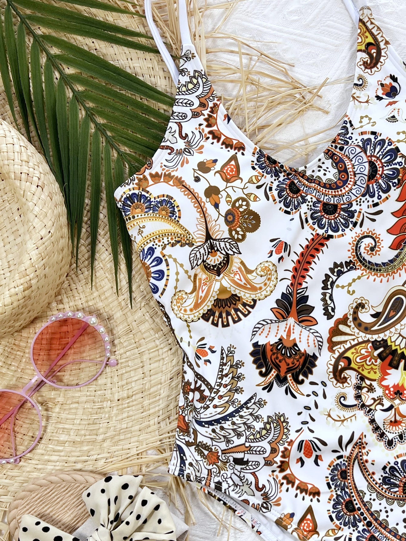White paisley printed one-piece swimsuit close-up, scoop neckline